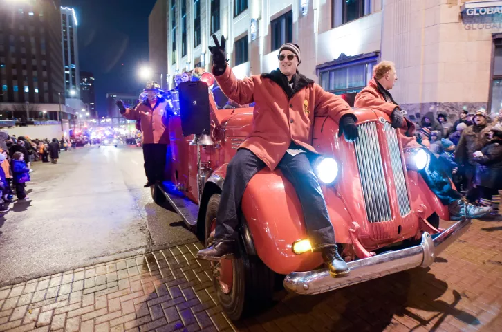 An old fire truck was a comfortable perch for a ride during the Winter Carnival Torchlight Parade, on Fifth Street in downtown St. Paul on Saturday, Feb. 6, 2016. (Special to the Pioneer Press: Craig Lassig)