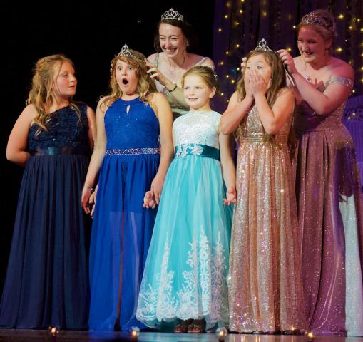 Junior Royalty Helen Nistler and Amora Jimenez receive their crowns from 2021-22 Princesses Haylie Magoon and Abby Shoutz Sunday. Looking on are junior royalty candidates Kyra Urdahl and Brinley Miller.
