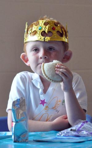 4-year-old Kray Penk proves even a king needs a snack break as he munches on a peanut butter and jelly sandwich.