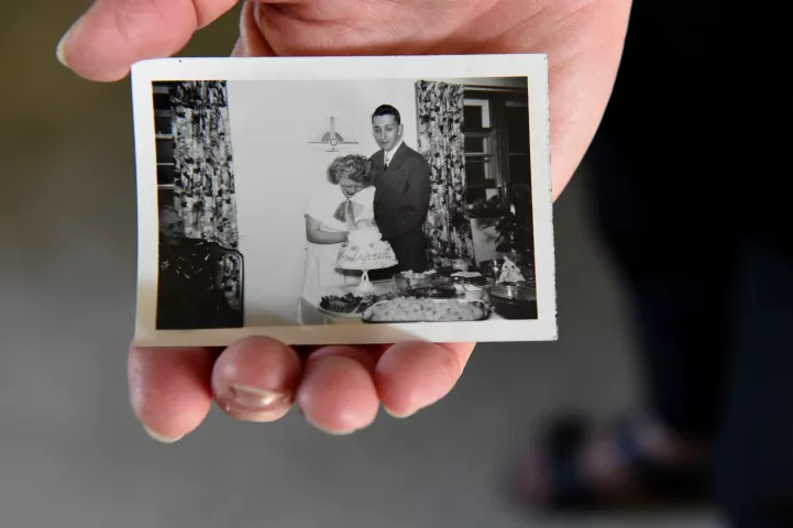 A daughter holds an old photo of Bob and Yvonne Momsen, taken at a reception sometime after their 1948 wedding, at the couple's Mendota Heights home on Friday, Sept. 7, 2018. They will celebrate their 70th wedding anniversary on Sept. 11, 2018. (Jean Pieri / Pioneer Press)