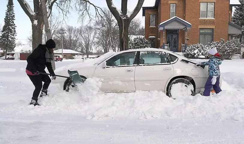 Becky Hopp gets help from her daughter Haley, 8, in digging out a car Monday, Jan. 28, 2019, in North Mankato, Minn. (Pat Christman/The Free Press via AP)