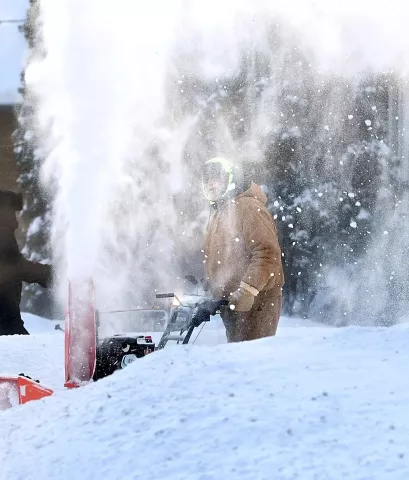 Mike Hoffman is surrounded by snow from his snowblower as he clears his driveway Monday, Jan 28, 2019, in Mankato, Minn. (Pat Christman/The Free Press via AP)