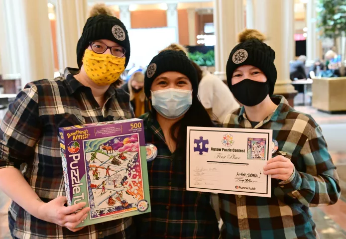 Friends, from left, Caroline Beattie, Ronadel Ronquillo, Kara Eerstad, and, not pictured, Elynn Horn show off their puzzle and first place award in the Adult 1 category in the St. Paul Winter Carnival Puzzle Contest at the Landmark Center in downtown St. Paul on Saturday, Jan., 30, 2021. Sponsored by PuzzleTwist, roughly 150 teams in four categories competed to complete puzzles in the fastest time. (John Autey / Pioneer Press)
