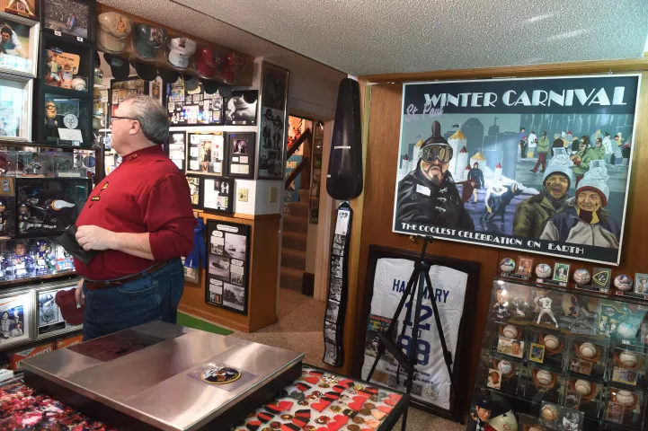 Tom Barret shows off a portion of his collection of memorabilia in the basement of his home on Wednesday, Jan. 12, 2022. Barrett is depicted in the Winter Carnival painting on the wall, as the 2004 Vulcanus Rex. (Scott Takushi / Pioneer Press)