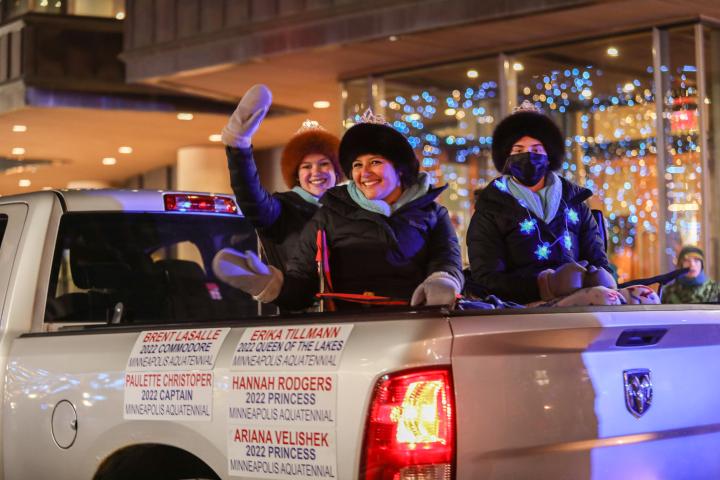 Princesses of the Minneapolis Aquatennial wave to the crowd as their ride passes during the Vulcan Victory Torchlight Parade Saturday, Feb. 5, 2022. (Hannah Hobus / Pioneer Press)
