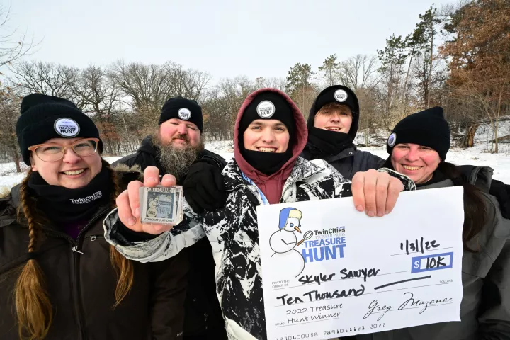 Skyler Sawyer, center, is joined by his stepmom Liz McMann, from left, his dad Michael, his brother Griffin and friend Emily Malcolm for a photo after Skyler found the Pioneer Press Treasure Hunt medallion at Silverwood Park in St. Anthony on Monday, Jan. 31, 2022. The St. Paul family are avid Treasure Hunters. (John Autey / Pioneer Press)